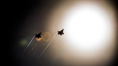 A pair of F-35 Lightning IIs pass under the sun while doing maneuvers to the Eglin Air Force Base runway